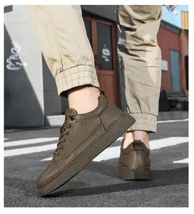 Close-up side view of men's brown leather sneakers on a street with zebra crossing.