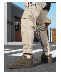 Outdoor street view of men's brown leather casual shoes worn with khaki pants