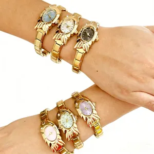 Close-up detail of luxury women gold bracelet watches with colorful oval dials