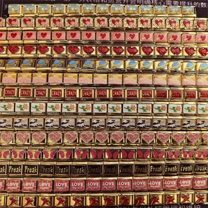 Detailed macro view showing multiple gold DIY modular charms with colorful enamel designs