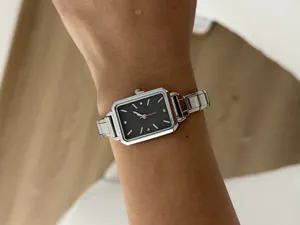 Close-up of elegant women's square quartz watch with silver stainless steel strap