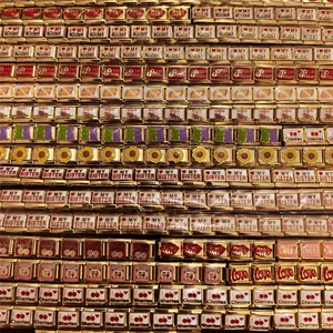 Detailed view of various DIY modular stainless steel bracelet links with 18K gold finish