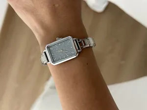 Elegant silver rectangular ladies quartz watch featuring a glittery grey dial on wrist