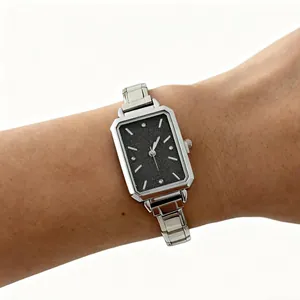 Elegant rectangular quartz watch for women featuring a silver stainless steel band on wrist