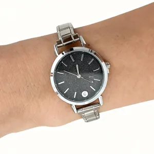 Close-up of a silver stainless steel modular link watch on a human wrist