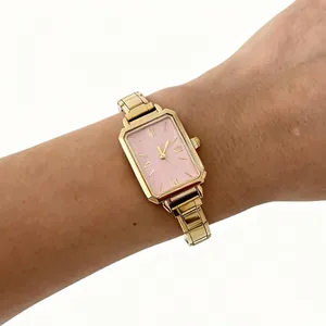 Close-up shot of an elegant women's gold steel watch featuring a soft pink dial