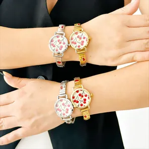 Detail view of stylish ladies quartz watches featuring red cherry prints and modular metal bands.