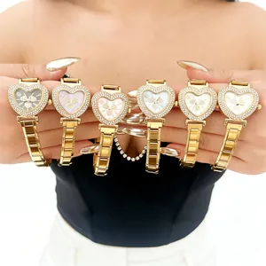 Close-up display of a collection of heart-shaped luxury women's watches with rhinestone bezels