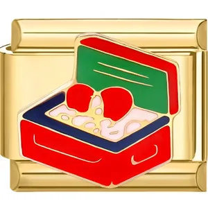 Detail of golden Italian charm with red suitcase and heart enamel for DIY bracelets
