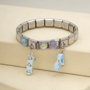 Close-up of stainless steel Italian charm bracelet with ocean charms and skateboard pendant
