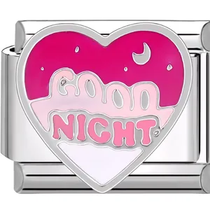 Macro detail of heart-shaped charm link featuring Good Night text and moon motif