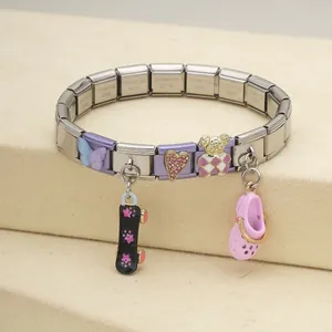Close-up of an Italian modular stainless steel charm bracelet with colorful pendants.