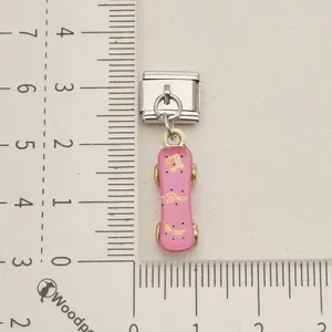 Macro view of a pink skateboard Italian modular charm with golden musical note patterns