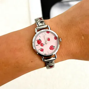 Detailed view of women's quartz watch featuring strawberry pattern dial and modular strap