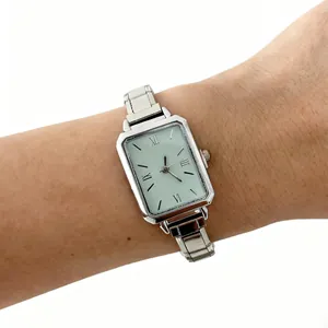Detailed shot of a classic silver steel band quartz watch for women on a human wrist