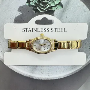 Close-up of elegant gold-toned women's quartz watch with oval dial and link band.