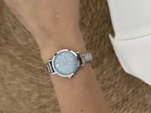 Detailed view of fashionable silver stainless steel modular watch with glittery blue dial
