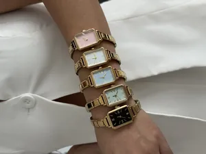 Detailed view of five vintage-style rectangular quartz watches with gold steel bands