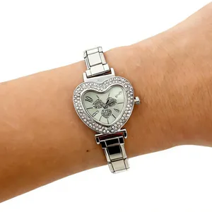 Macro view of heart-shaped silver watch with sparkling rhinestone bezel and modular band