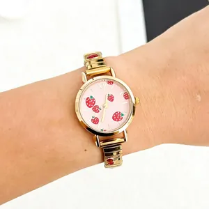 Detailed view of women's quartz watch featuring pink strawberry dial and cherry band