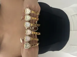 Macro detail of six heart-shaped quartz watches with rhinestone bezels and steel bands.