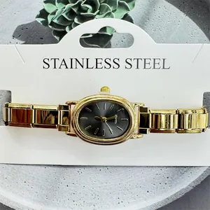 Close-up of golden women's quartz watch with oval dial and stainless steel band