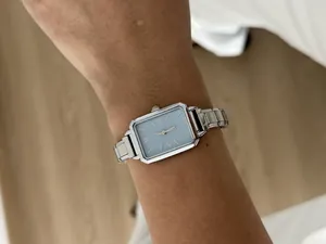 Detailed view of an elegant ladies' rectangular quartz watch with a light blue dial