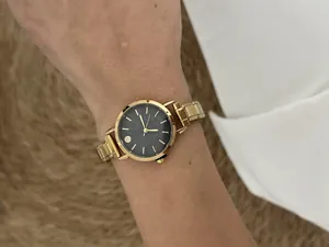 Detailed view of fashionable gold modular watch with a black starry dial on wrist