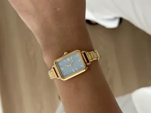 Elegant gold-tone rectangular ladies quartz watch with blue dial and link bracelet detail