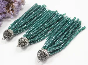 Close-up of green crystal beaded tassels with rhinestone caps for DIY jewelry crafts