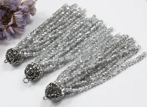 Detailed view of silver crystal tassels with rhinestone caps for DIY jewelry making.
