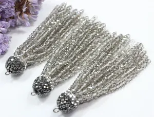 Detailed macro view of faceted grey crystal bead tassels with pavé rhinestone caps for jewelry