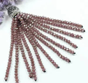 Detailed macro shot of a dusty pink crystal beaded tassel pendant for DIY jewelry making