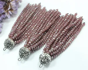 Macro detail view of three faceted crystal bead tassels with pave rhinestone caps