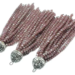 Handmade dusty rose crystal bead tassels with shimmering rhinestone caps for DIY jewelry.