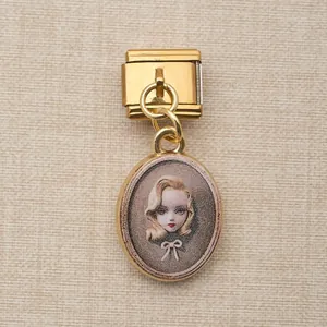 Vue détaillée d'un module de charme italien doré avec un pendentif d'image vintage.