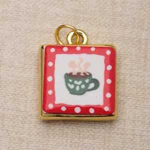 Close-up detail of a square copper pendant featuring a hand-painted green coffee cup design