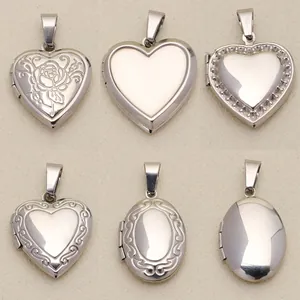 Close-up detail of vintage silver-tone heart and oval engraved metal locket pendants.