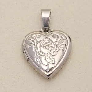 Detailed view of a vintage silver heart-shaped locket with floral rose carving
