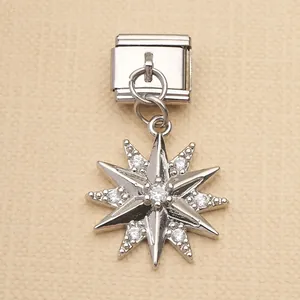 Macro view of a silver stainless steel Italian charm module featuring a sparkling star pendant