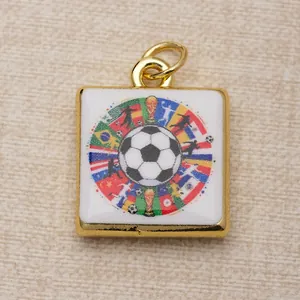 Macro detail of a square copper soccer pendant with colorful flag and player graphics.