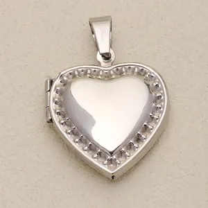 Close-up view of a polished silver heart-shaped locket pendant with decorative border