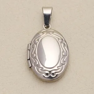 Detailed macro view of vintage engraved silver polished oval locket jewelry pendant