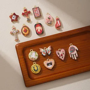 Detailed view of various retro enamel charms including heart, cat, and cross designs.