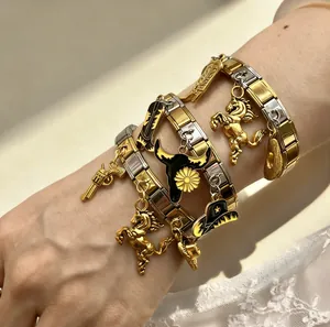 Detail of gold and silver Italian modular bracelet with horse and cowboy charms