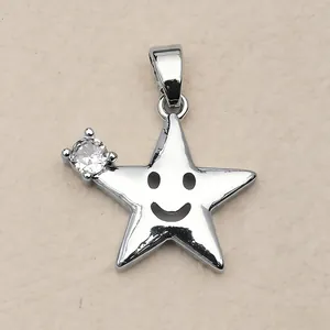 Detailed view of a silver star pendant with a smiley face and a sparkling gemstone