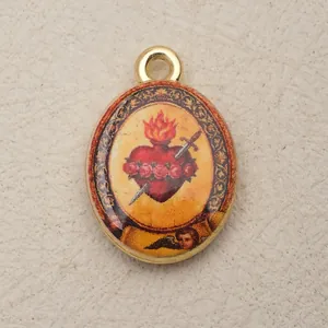 Detailed view of an oval vintage Sacred Heart pendant with sword and rose motifs.
