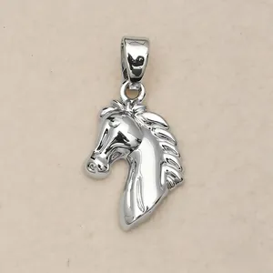 Close-up detail of a polished silver-colored horse head pendant with intricate mane