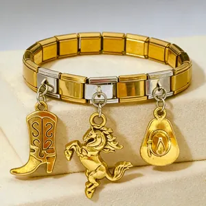 Close-up of Italian modular stainless steel bracelet with gold horse and cowboy hat charms.