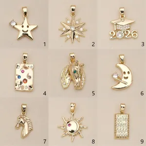 Nine assorted gold copper pendants featuring sun moon horse and graduation designs
